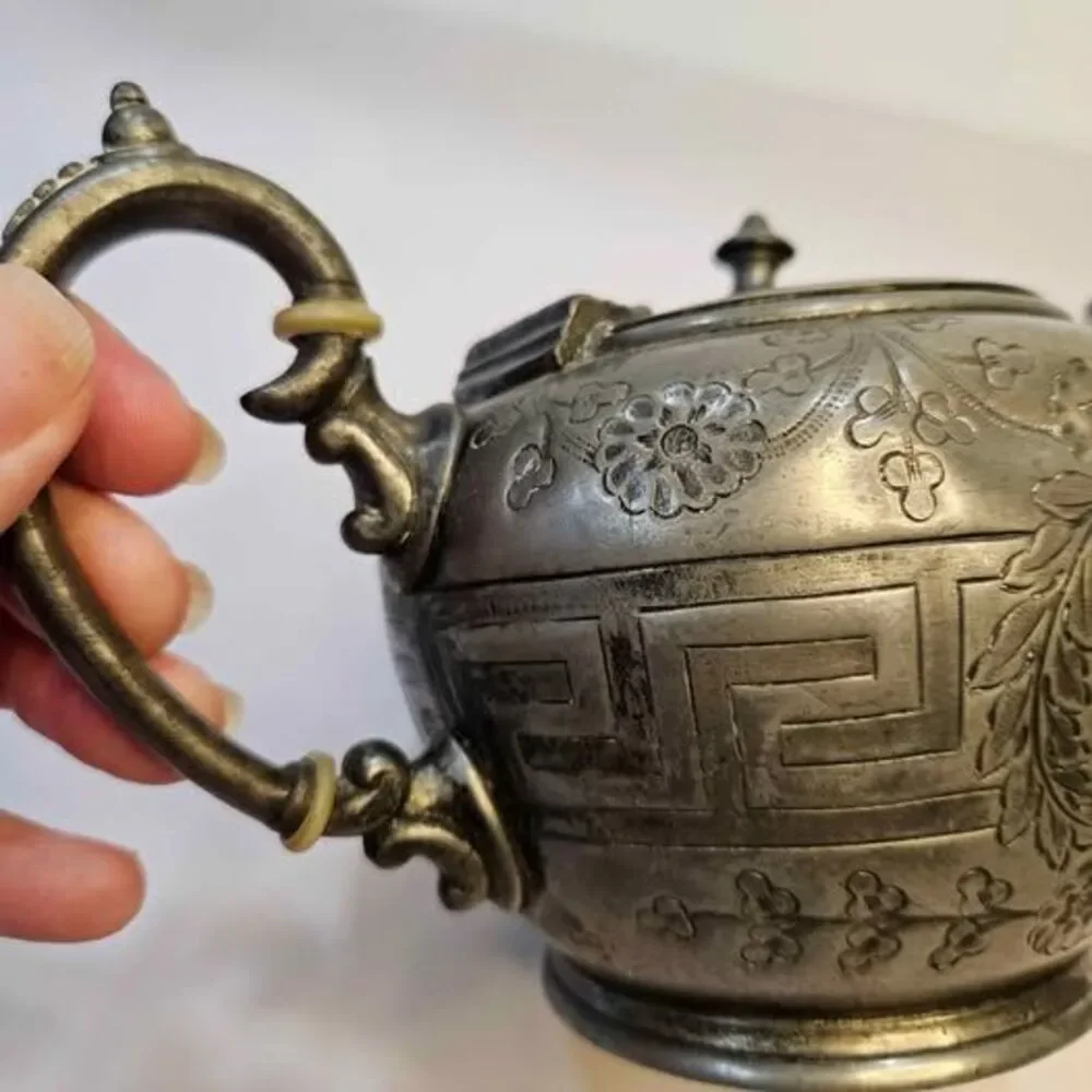 Antique silver-plated teapot Greek key pattern & embossed floral motifs.